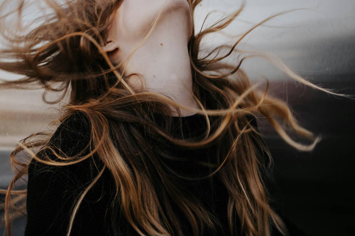Woman in yoga pose with dynamic hair style that stays intact during movement