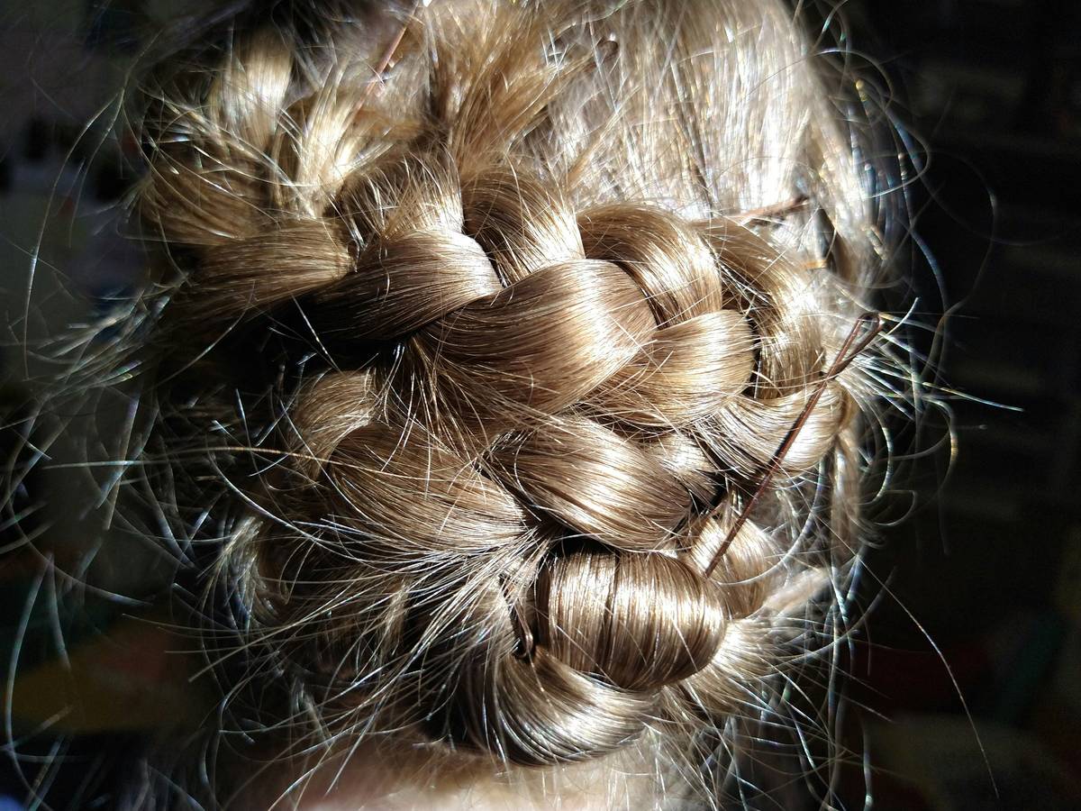 Woman in yoga pose wearing a secure twisted updo that stays intact during movement