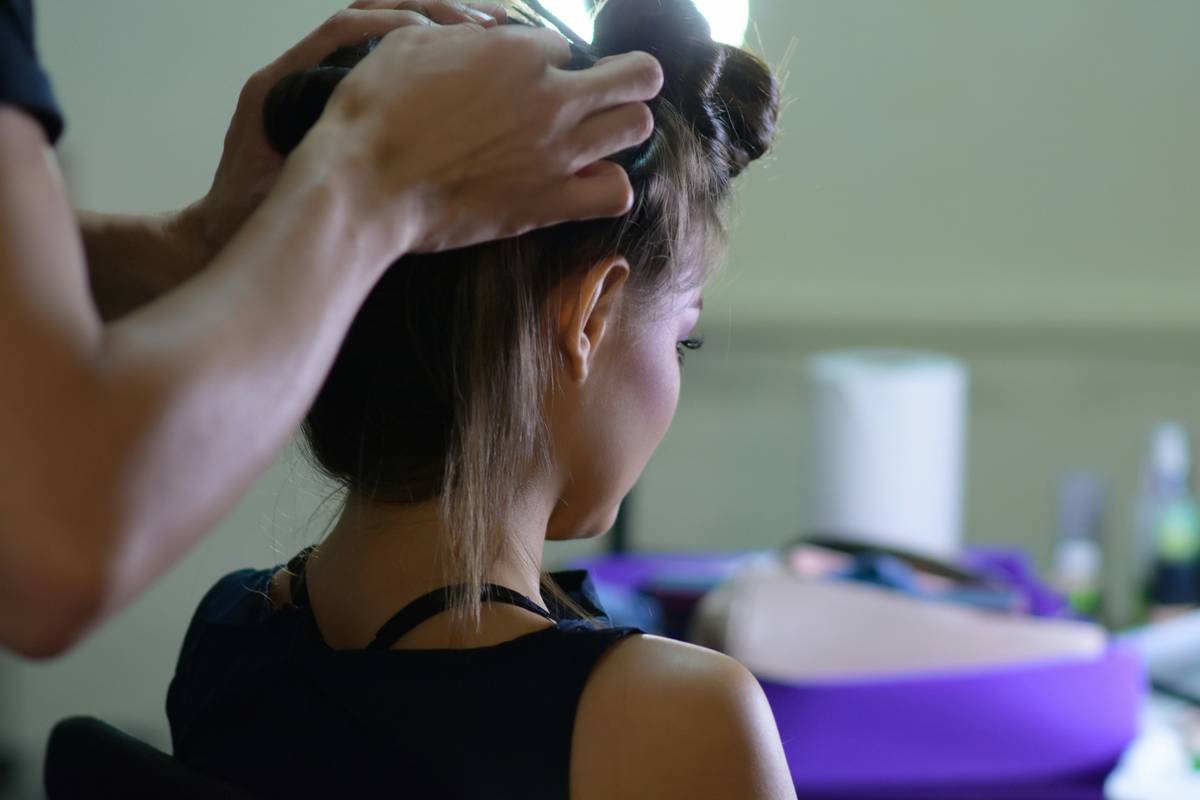 Woman in yoga pose with sleek high ponytail showcasing sporty hair vibe